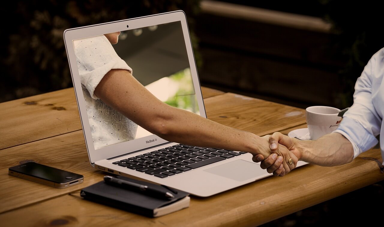 handshake through a laptop